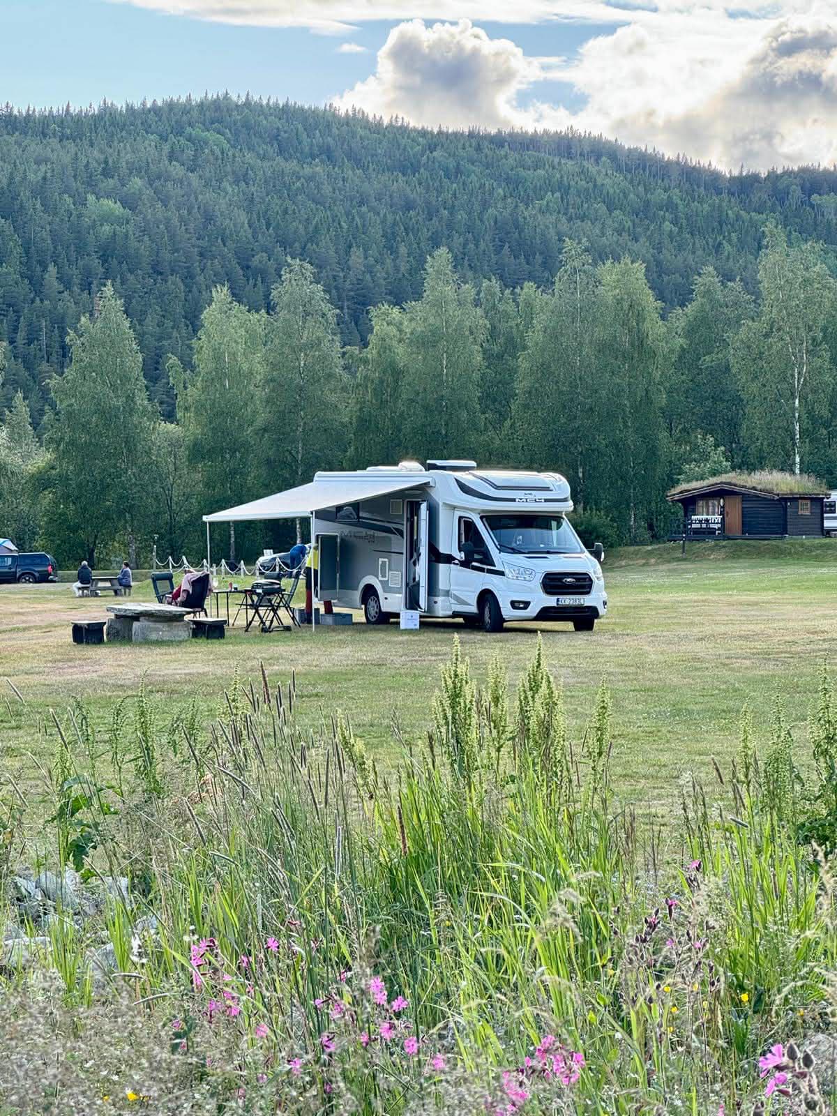 Para ciesząca się kawą przy kamperze nad jeziorem